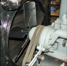 Halftrack fan belt and pulley assembly close-up with steering wheel visible