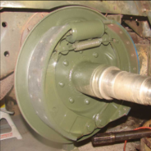 Halftrack brake drum painted green with axle