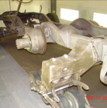 Halftrack front axle and suspension assembly in paint booth