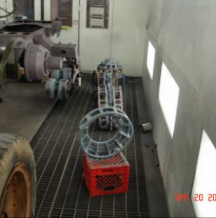 Track components laid out on paint booth floor