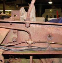 Frame cross member with wiring and bolts