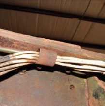 Frame cross member with wire bundle clamp