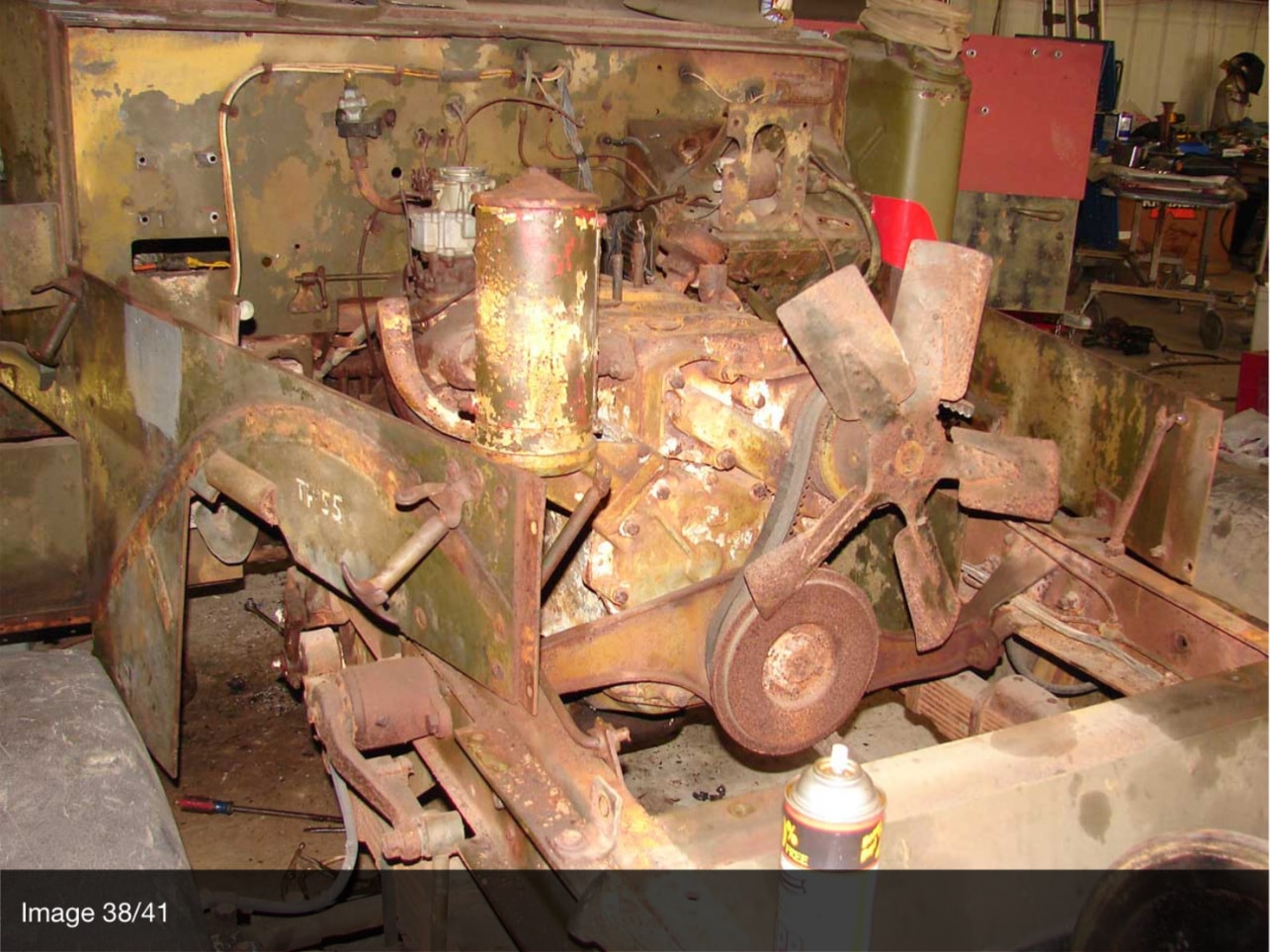 Halftrack engine in bay with original paint and rust getting started