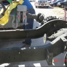 Halftrack frame with yellow lifting straps attached to engine