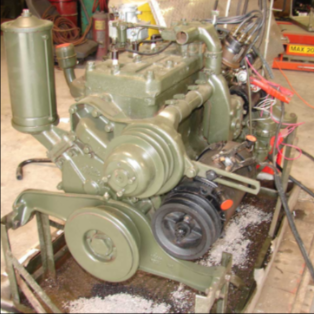 Rebuilt olive drab halftrack engine on stand ready for installation