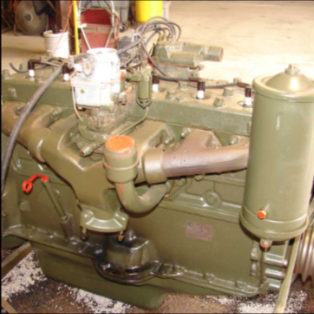 Rebuilt halftrack engine side view with oil filter and components