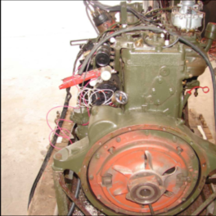 Halftrack engine with red flywheel and transmission attached