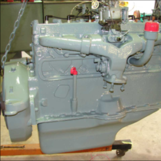 Fully rebuilt halftrack engine painted gray on workbench
